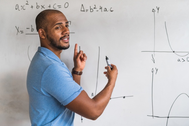 Black Male Math teacher at whiteboard-1