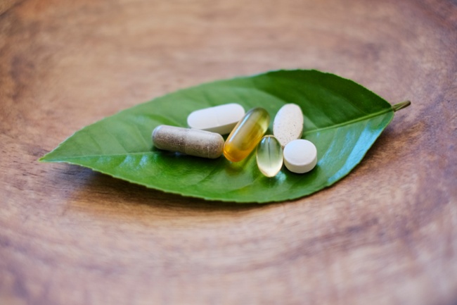 naturally sourced supplements on a green leaf