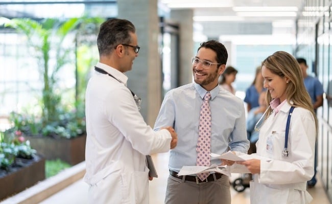 healthcare business manager talking to doctors