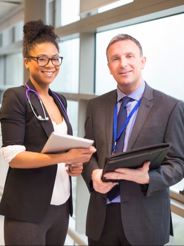 healthcare administrator and doctor in a discussion