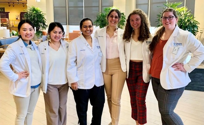 Concordia pharmacy students with white lab coats