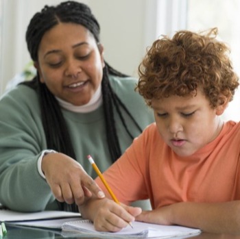 teacher helping a student with writing